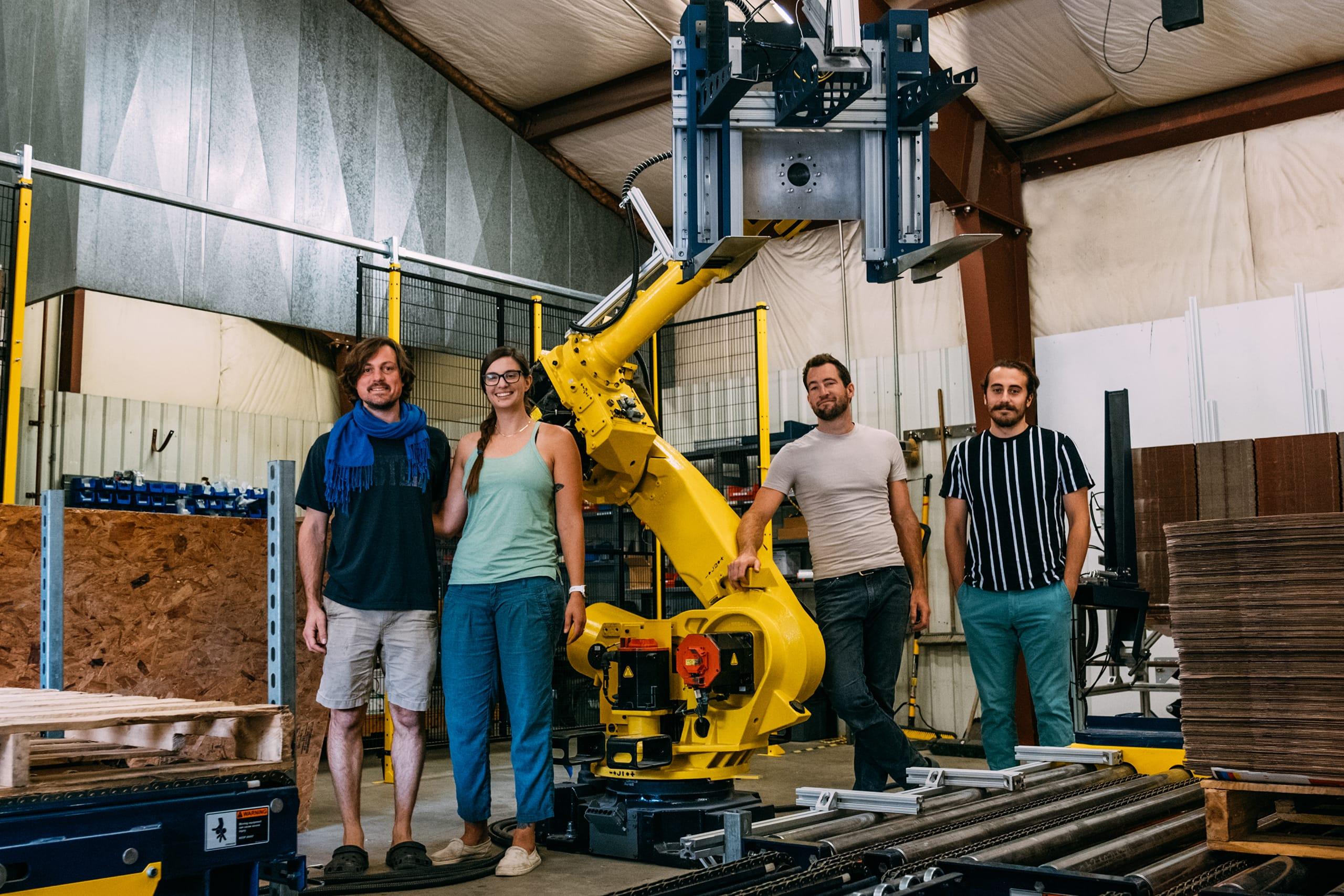 The Rigorous team stand in front of the Box Hopper robot.