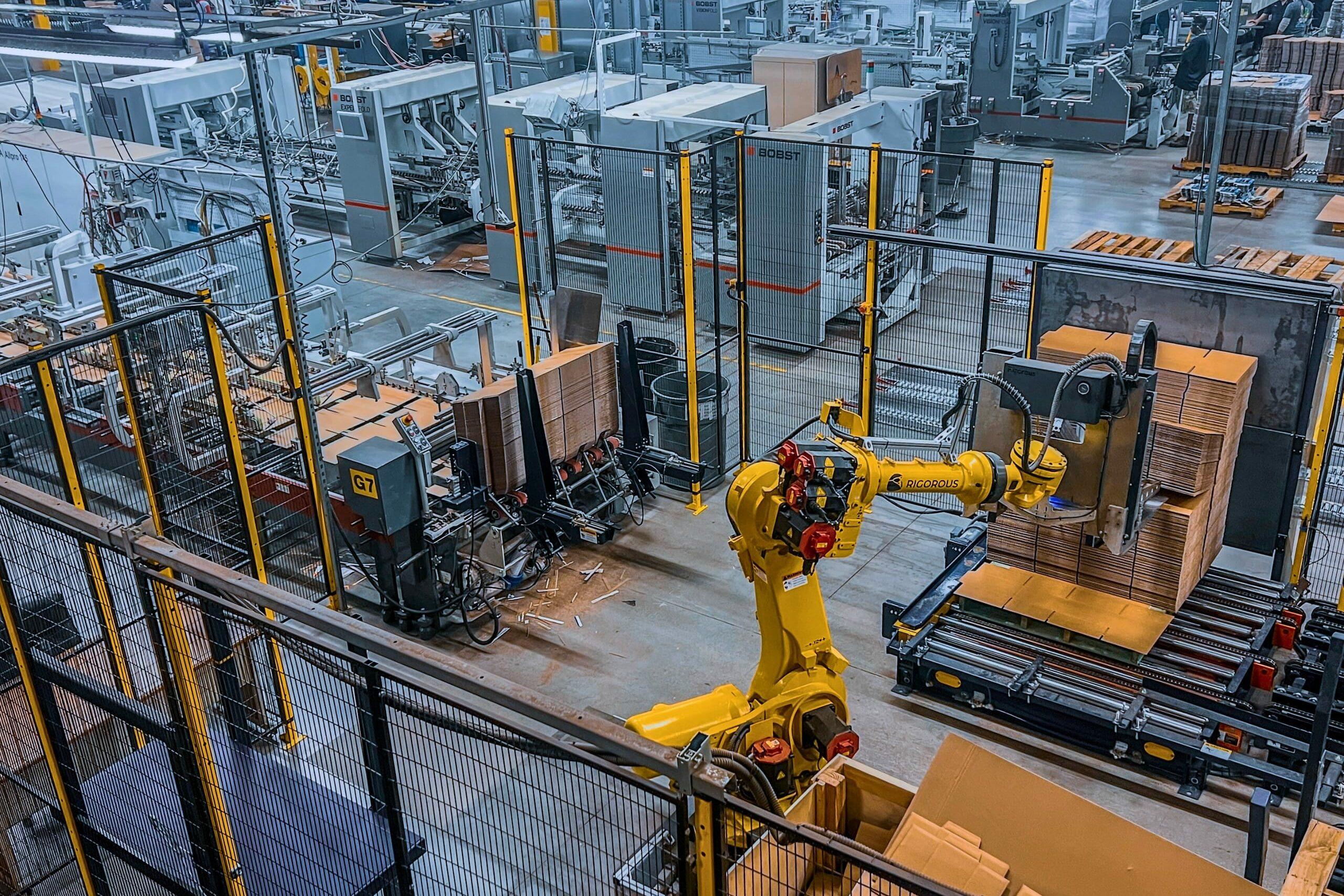 View from above of the Accurate Box Co. corrugated manufacturing line including a smart pre-feed robot.